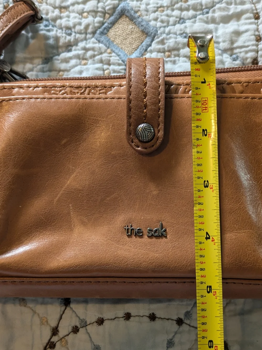 The Sak tan leatherette crossbody wristlet